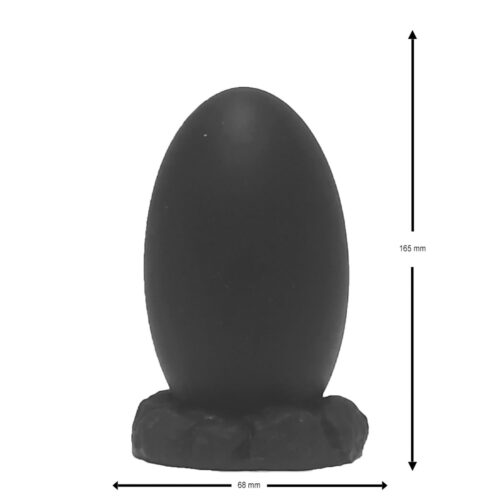Black egg-shaped object on a textured base