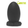 Black egg-shaped object on a textured base