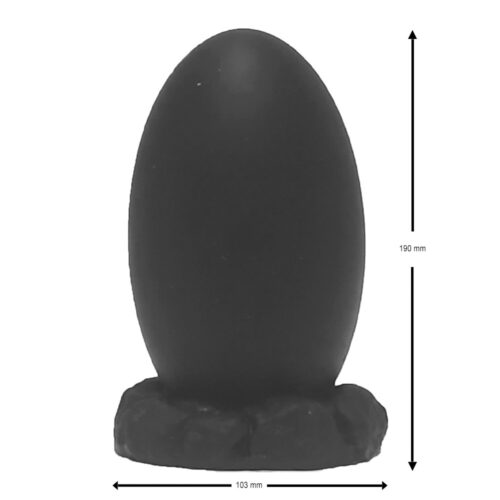 Black decorative egg on a textured base