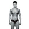 Muscular man in black underwear, posing against a white background