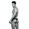 Muscular man in black swimwear poses from behind