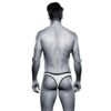 A man in a black and white thong stands with his back to the camera