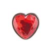 A red heart-shaped gem, featuring a faceted surface and silver framing