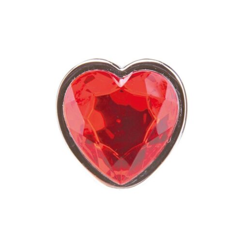 A red heart-shaped gem, featuring a faceted surface and silver framing
