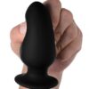 Black silicone plug held in a hand