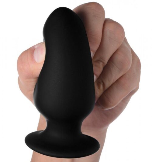 Black silicone plug held in a hand