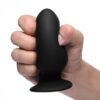 Black silicone adult toy held in hand