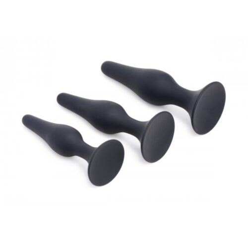 Three black silicone anal plugs of different sizes