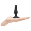 A black silicone toy held in a hand