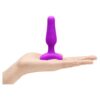 Purple silicone anal toy in a hand