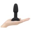 Black silicone toy held in a hand