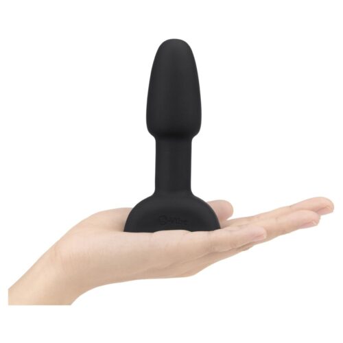 Black silicone toy held in a hand