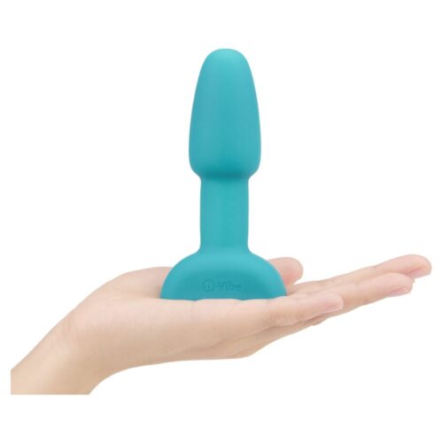 Teal silicone plug held in a hand