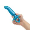 A hand holding a blue silicone toy with a tapered end