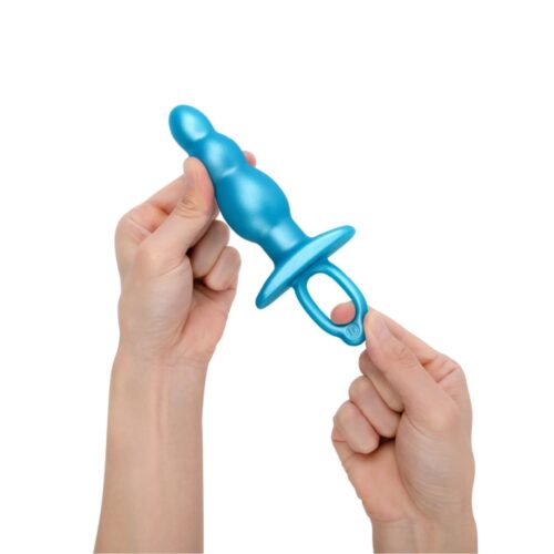 A blue silicone toy held in a hand