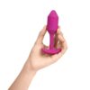 Experience Pleasure With This Stylish Pink Silicone Toy, Perfect For Exploration. A Hand Holding A Pink Silicone Adult Toy, Available At The Loving Company.