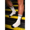 Two legs in white iSWALLOW socks on yellow stairs
