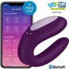 Satisfyer Double Joy Vibrator in purple next to a smartphone displaying the Satisfyer app
