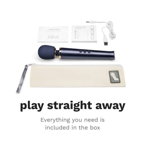 Le Wand Petite Rechargeable Wand Vibrator Massager with user guide, USB cable, and storage pouch, available at The Loving ...