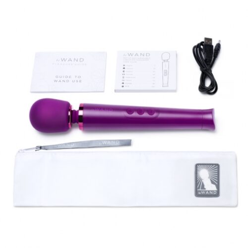 Le Wand Petite Rechargeable Wand Vibrator Massager in purple, with user guides, a charging cable, and pouch, available at ...