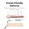 Le Wand Powerful Plug In Vibrating Wand Massager with pink head, charger, plug adaptors, and carrying pouch available at T...