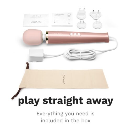 Le Wand Powerful Plug In Vibrating Wand Massager, charging adapter, plugs, and storage pouch, available at The Loving Comp...
