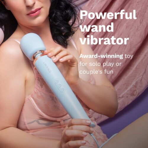 Le Wand Powerful Plug In Vibrating Wand Massager in blue held by a person
