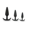 Three black silicone anal plugs of different sizes