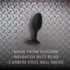 Black silicone weighted butt plug with carbon steel ball inside