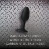 Black silicone weighted butt plug with carbon steel ball inside