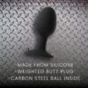 Black silicone weighted butt plug with carbon steel ball inside