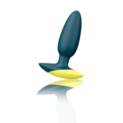 Toy in dark blue and yellow, reflecting on a smooth white surface