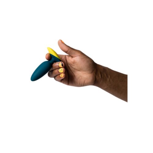 Colorful toy being held in a hand with playful nail art