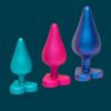 Three silicone toys in teal, pink, and blue