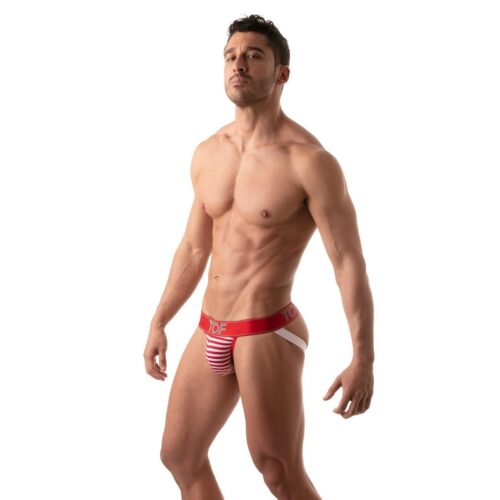 Muscular man wearing a red and white striped thong