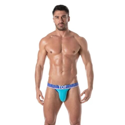 Muscular man in a blue thong with 'TOF GEAR' waistband