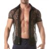 A muscular man in a sheer black floral lace shirt