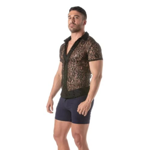 Model in a sheer black lace shirt and navy shorts