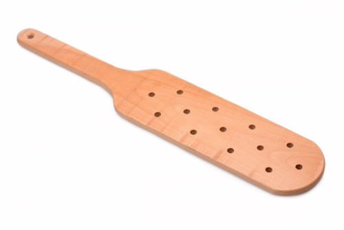 A tan wooden paddle with multiple holes
