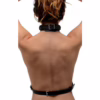 Elevate your style with this striking black chest harness. A woman’s back wearing a black chest harness