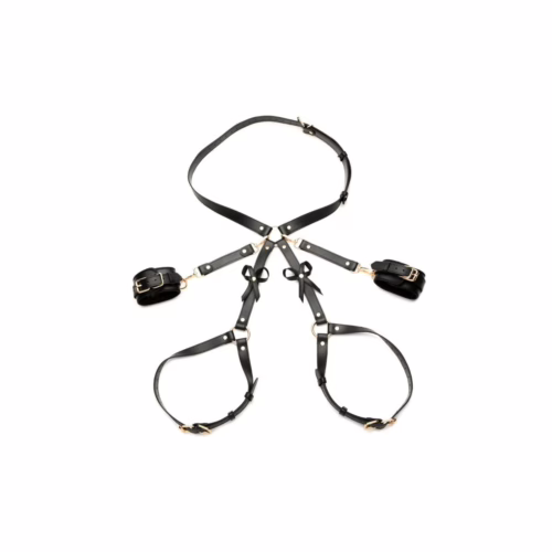 A black bondage harness with bows and gold accents
