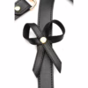 Black bondage harness with bows and gold accents