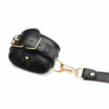 Black leather bondage harness with gold accents