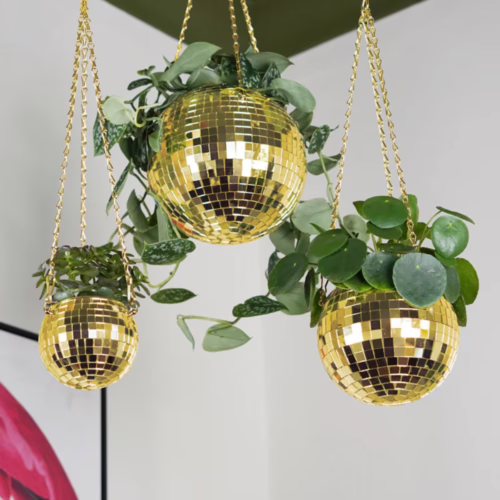 Add a touch of fun and greenery to your home with these disco ball hanging planters. Gold disco ball hanging planters with plants