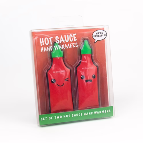 Stay warm with these fun hot sauce hand warmers, available at The Loving Company. Two hot sauce-shaped hand warmers with smiling faces in a clear package