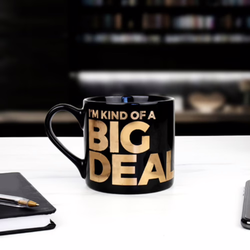 Sip in style with this humorous 'I'm Kind of a Big Deal' mug. Black mug with gold text 'I'M KIND OF A BIG DEAL'