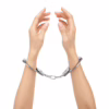 Silver metal handcuffs on two hands