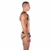 A man wearing a black Prowler Red Butch Harness, shown in profile view