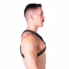 Side view of a man wearing a black and silver Prowler Red Ballistic Harness