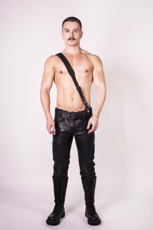 Model wearing a black leather outfit with a Sam Browne Belt